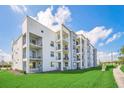 Modern apartment building with a landscaped green space at 4741 Clock Tower Dr # 208, Kissimmee, FL 34746