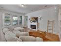Bright Gathering room featuring a cozy sectional sofa and fireplace at 9149 Outlook Rock Trl, Windermere, FL 34786