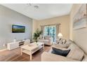 Living room with comfy sofas, a TV, and access to a balcony at 806 Lucaya Loop, Davenport, FL 33897