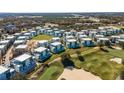 Aerial view of a modern townhome community near a golf course at 7740 Sandy Ridge Dr # 132, Reunion, FL 34747