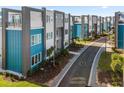Modern townhome community with sleek design and landscaping at 7740 Sandy Ridge Dr # 132, Reunion, FL 34747