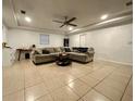Spacious living room with L-shaped couch and tile floors at 2554 Yale Rd, South Daytona, FL 32119