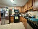 Dark wood cabinets, granite counters and stainless steel appliances at 2554 Yale Rd, South Daytona, FL 32119