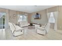 Spacious living room with white reclining sofas and a large TV at 8911 Stinger Dr, Champions Gate, FL 33896