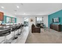 Open living space with teal accent wall and kitchen at 320 Ballo Dr, Kissimmee, FL 34746