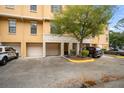View of townhome building with garages and landscaping at 6119 Metrowest Blvd # 106, Orlando, FL 32835