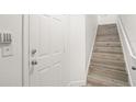 Interior entryway with white door and wood-look stairs at 6119 Metrowest Blvd # 106, Orlando, FL 32835