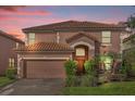 Two-story house with terracotta roof and double garage at 2616 Tranquility Way, Kissimmee, FL 34746