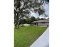 Newly renovated home with gray exterior, modern landscaping, and a welcoming front entrance at 19 Pine Court Loop, Ocala, FL 34472