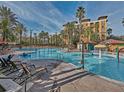 Large resort pool with water features and plenty of lounge chairs at 12538 Floridays Resort Dr # 401-C, Orlando, FL 32821