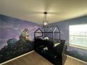 bedroom with bunk bed and custom wall mural at 4425 Durga Ln, Kissimmee, FL 34746