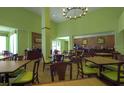 Hotel breakfast area with tables, chairs, and a beverage station at 3000 Maingate Ln # 522, Kissimmee, FL 34747