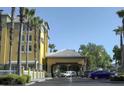 Hotel entrance with covered dropoff and ample parking at 3000 Maingate Ln # 522, Kissimmee, FL 34747