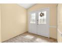 Bright entryway with tile flooring and double doors with stained glass accents at 9076 Sw 95Th Ave # 9076, Ocala, FL 34481