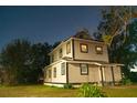 Two-story house with light beige vinyl siding, black window frames, and a small front yard at 1012 W Jefferson St, Orlando, FL 32805