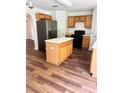 Island kitchen features stainless steel appliances and wood cabinets at 1856 Emily Dr, Winter Haven, FL 33884