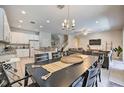 Open kitchen and dining area with modern appliances and island at 742 Orange Cosmos Blvd, Davenport, FL 33837