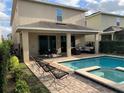 Inviting pool area with patio furniture and spa at 7405 Marker Ave, Kissimmee, FL 34747