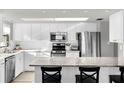 Modern kitchen with white cabinets, granite counters, and stainless steel appliances at 4445 S Atlantic Ave # 606, Ponce Inlet, FL 32127