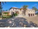 Grand two-story home with a large driveway and Mediterranean architecture at 4200 Down Point Ln, Windermere, FL 34786