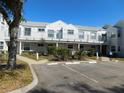 Exterior view of a two-story building with parking and landscaping at 2540 Woodgate Blvd # 204, Orlando, FL 32822