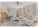 Bright and airy living room with comfortable seating and hardwood floors at 2881 Kokomo Loop, Haines City, FL 33844