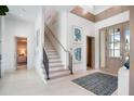 Bright and airy entryway with modern staircase and views to a bedroom at 4007 Grande Brick Loop # 13, Orlando, FL 32837
