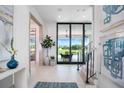 Entryway with view to golf course, showcasing sliding glass doors and modern decor at 4163 Grande Brick Loop # 19, Orlando, FL 32837