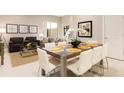 Modern dining area with a spacious wooden table and comfortable seating for six at 7538 Sunville Ave, Kissimmee, FL 34747