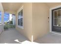 Covered front porch with white railings and black door at 1909 Tropical Palms Cir, Kissimmee, FL 34747