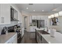 Modern kitchen with white cabinets and large island at 4751 Clock Tower Dr # 402, Kissimmee, FL 34746