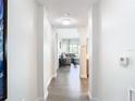 Bright hallway with wood-look floors leading to living area at 14501 Grove Resort Ave # 3327, Winter Garden, FL 34787