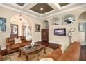 Spacious living room featuring hardwood floors, comfortable seating, and an inviting atmosphere at 6443 Cartmel Ln, Windermere, FL 34786