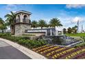 Attractive community entrance with water feature and landscaping at 14563 Orchid Island Dr, Orlando, FL 32827
