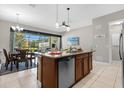 Kitchen island with seating and view into dining area at 193 Captiva Dr # 193, Davenport, FL 33896