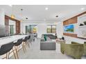 Open concept living area with modern furniture and large TV at 6115 High Seas Dr, Orlando, FL 32821