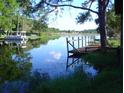 Picturesque view of a serene lake with a private dock for enjoying the waterfront at 1333 N Fowler Dr, Deltona, FL 32725