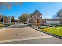 Brick paver road leads to the gated entrance of Trilogy community at 283 Silver Maple Rd, Groveland, FL 34736