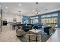 Open living room and kitchen with modern decor and blue walls at 1758 Oak Blossom Dr, Davenport, FL 33837