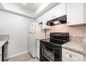 Modern kitchen with white cabinets and granite countertops at 5089 Eaglesmere Dr # D09, Orlando, FL 32819