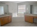 Large bathroom with double sinks and a corner tub at 2887 Sweetspire Cir, Kissimmee, FL 34746