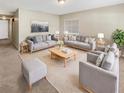 Spacious living room featuring neutral colored couches and a coffee table at 326 Banyan Dr, Maitland, FL 32751