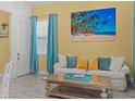 Living room featuring a comfy sofa, large artwork, and coastal decor at 3054 Pirate Way, Kissimmee, FL 34747