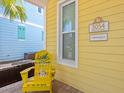 Inviting exterior with a yellow house and a yellow chair on the porch at 3054 Pirate Way, Kissimmee, FL 34747