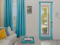 Bright and airy entryway with teal door and coastal decor at 3054 Pirate Way, Kissimmee, FL 34747