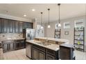 Kitchen island with granite countertops and dark cabinetry at 3466 Halsway Dr, Orlando, FL 32824