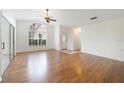 Spacious living area with hardwood floors and an arched window at 2546 Albion Ave, Orlando, FL 32833