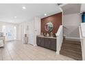 Elegant entryway showcasing a stylish console table and staircase at 7713 Graben St, Kissimmee, FL 34747