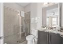 Clean bathroom with a walk-in shower and granite countertop at 7713 Graben St, Kissimmee, FL 34747