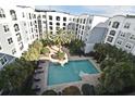 Aerial view of a community pool surrounded by palm trees at 304 E South St # 4027, Orlando, FL 32801